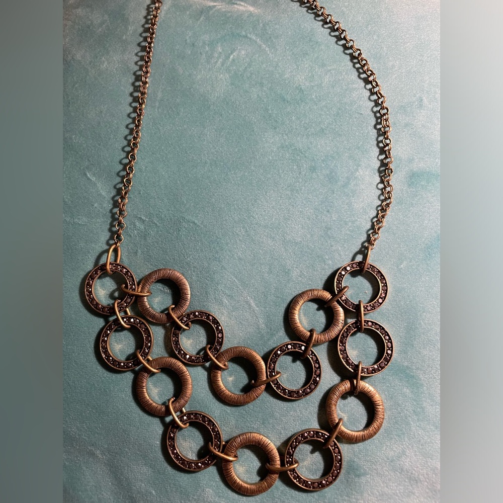 Antique gold tone statement piece with black rhinestone accents.